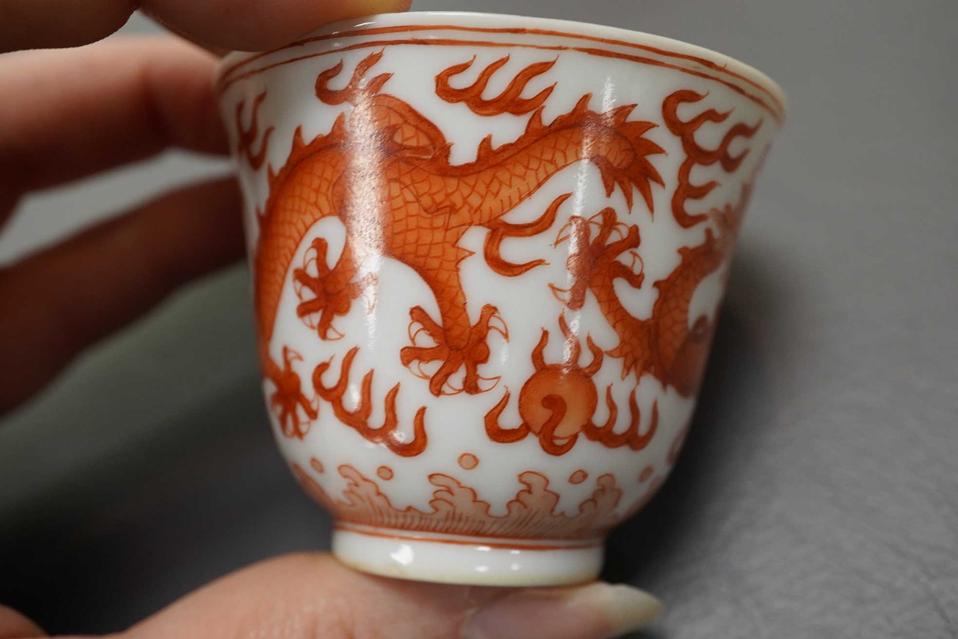 A pair of Chinese iron red ‘dragon’ cups, Guangxu six character mark and probably of the period (1875-1908)